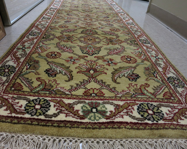 Appraisal: HAND KNOTTED ORIENTAL HALL RUG Indo-Persian overall floral design on