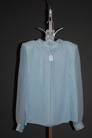 Appraisal: Andr Laug light blue long sleeve silk blouse with quilted