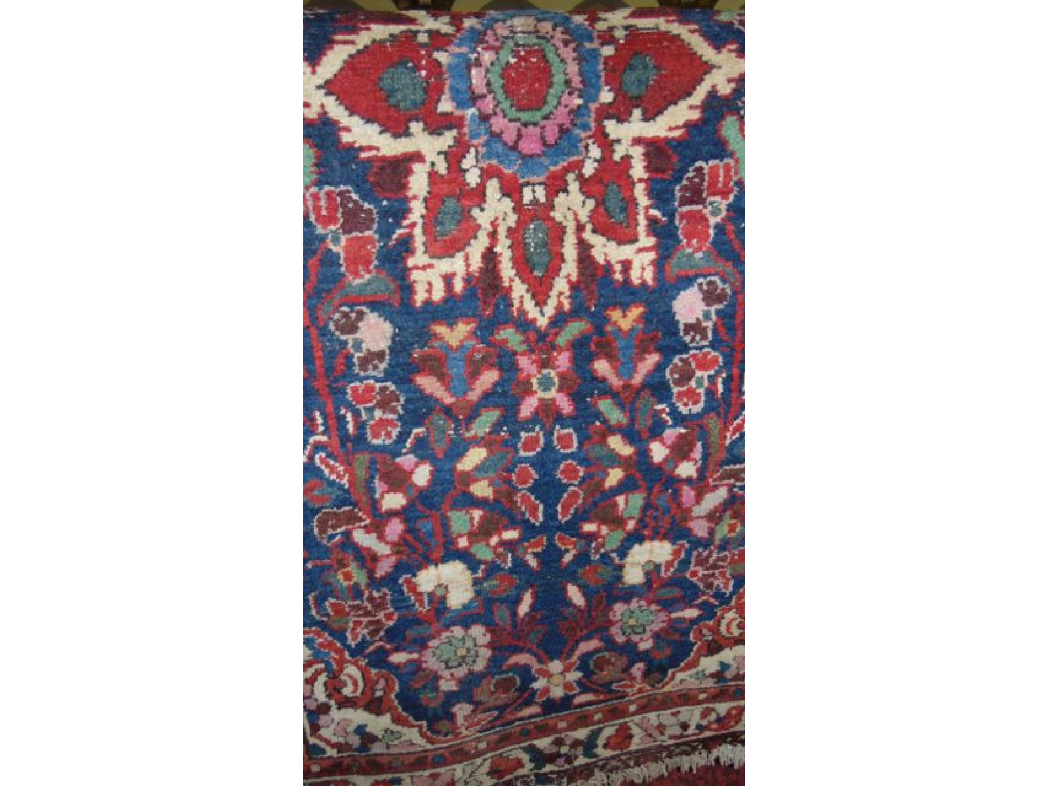 Appraisal: A coarse wool eastern rug the central flower burst medallion