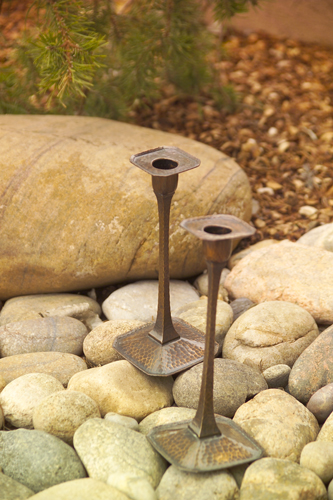 Appraisal: ROYCROFT Pair of hammered copper candlesticks with four-sided stems on