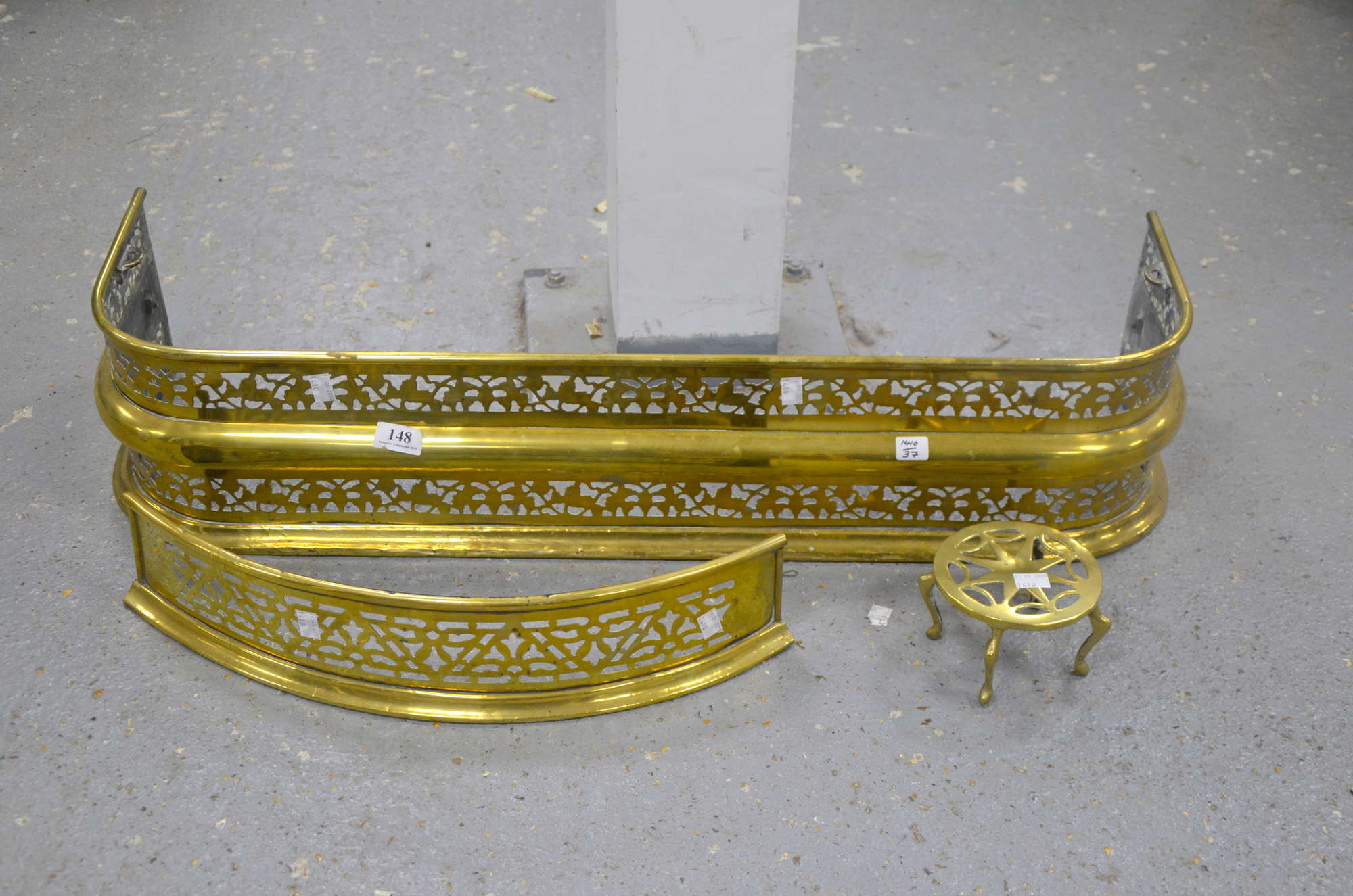 Appraisal: Brass fire fender together with another smaller and a brass