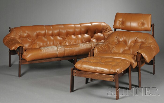 Appraisal: Brazilian Sofa Armchair and Ottoman Rosewood and leather s Caramel