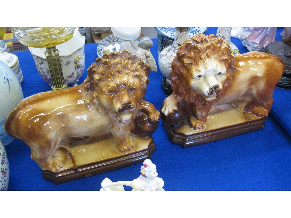 Appraisal: Pair of Bo'ness style figures of lions with one paw