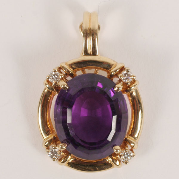 Appraisal: Gold K enhancer fitted with an oval deep purple amethyst