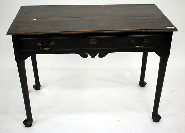 Appraisal: A GEORGIAN OAK SIDE TABLE with single frieze drawer scroll