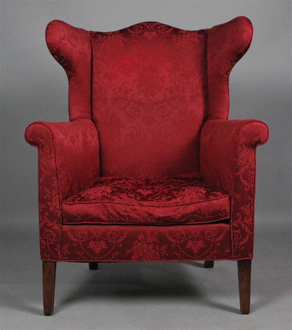 Appraisal: NEOCLASSICAL STYLE RED UPHOLSTERED WING CHAIR having an arched crest