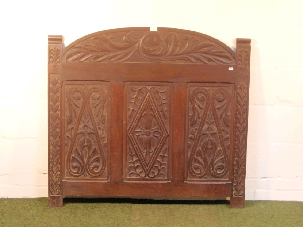 Appraisal: An oak bed head or panel with period carving cm