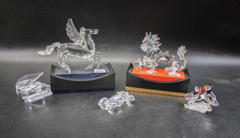 Appraisal: FIVE CRYSTAL SWAROVSKI FIGURINES Pegasus with stand Dragon with stand