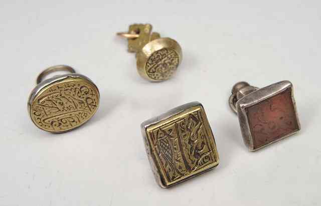 Appraisal: THREE SILVER MOUNTED ISLAMIC SEALS and a further brass seal