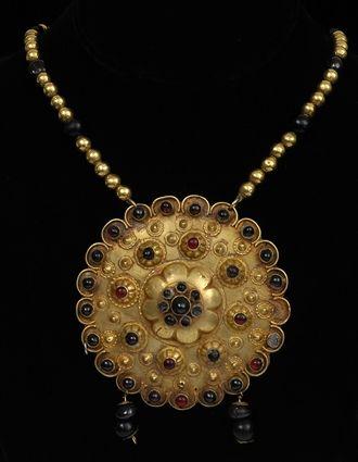 Appraisal: PERSIAN GOLD AND GARNET NECKLACE WITH PENDANT in pendant in