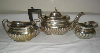 Appraisal: A THREE PIECE TEA SET of rounded oblong half fluted