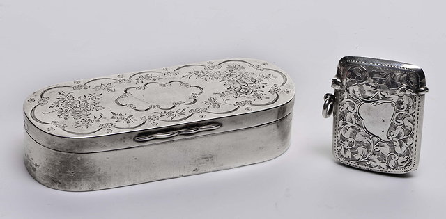 Appraisal: AN EDWARDIAN SILVER BOX oval shaped with hinged lid engraved