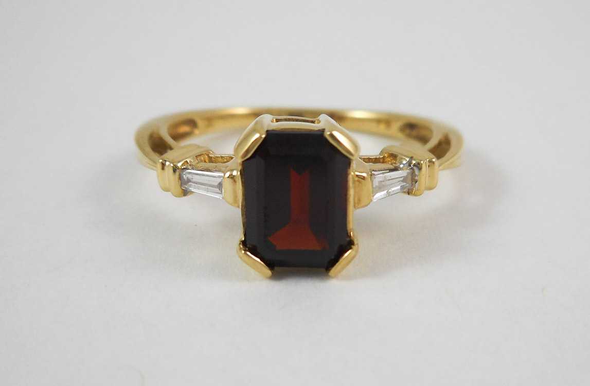 Appraisal: GARNET DIAMOND AND TEN KARAT GOLD RING with a baguette