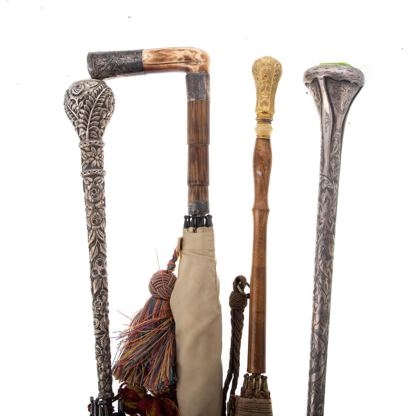 Appraisal: FOUR STERLING-MOUNTED UMBRELLAS Including one with bone handle the band