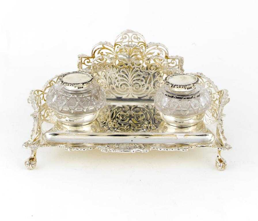 Appraisal: AN EDWARD VII CARTOUCHE SHAPED INKSTAND the foliate pierced three