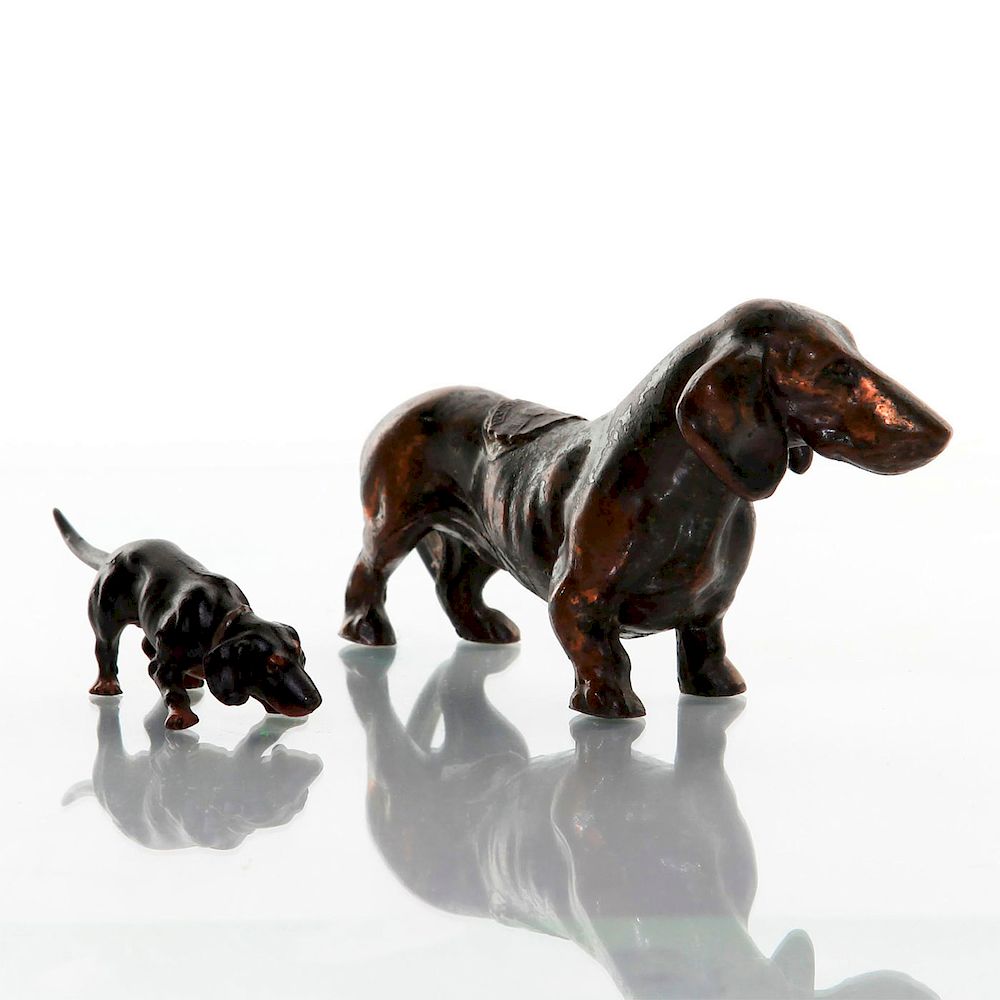 Appraisal: BRONZE DACHSCHUND FIGURINES Larger dog has a US Capitol Washington