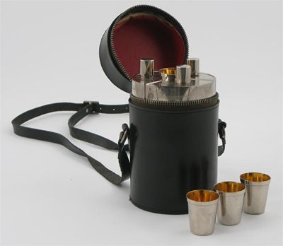 Appraisal: A German electroplate travelling flask set comprising three curved flasks