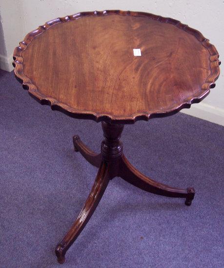 Appraisal: A mahogany circular table with piecrust border on a turned