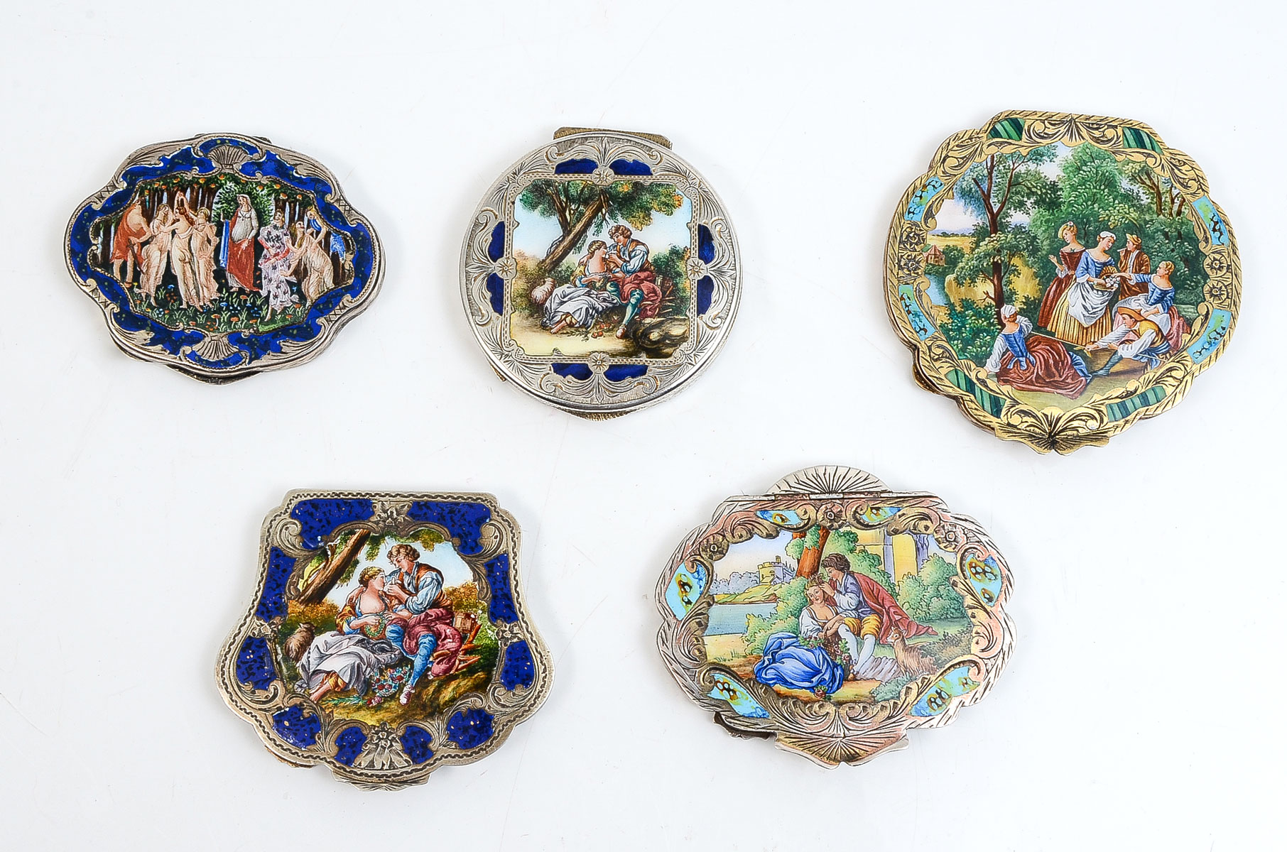 Appraisal: CONTINENTAL ENAMELED GILT SILVER COMPACTS Beautifully done scene of men