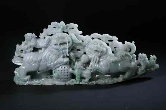 Appraisal: CHINESE APPLE GREEN AND CELADON JADEITE FU LION GROUP -