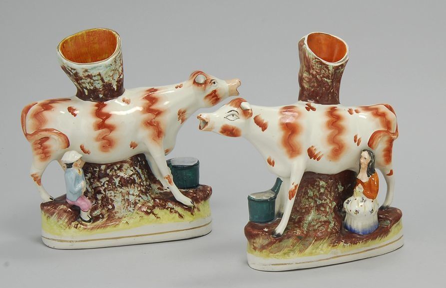 Appraisal: PAIR OF STAFFORDSHIRE COW-FORM SPILL HOLDERS Circa Rust-red and white