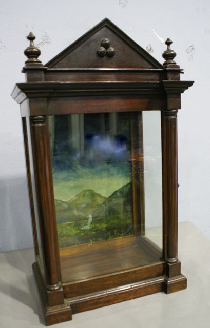 Appraisal: A small mahogany cabinet with painted landscabe scene to interior