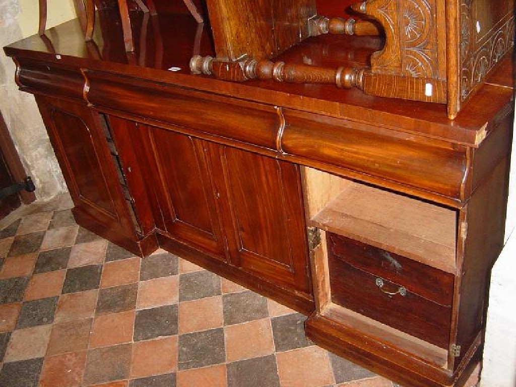 Appraisal: A Victorian mahogany door inverted break front sideboard with arched