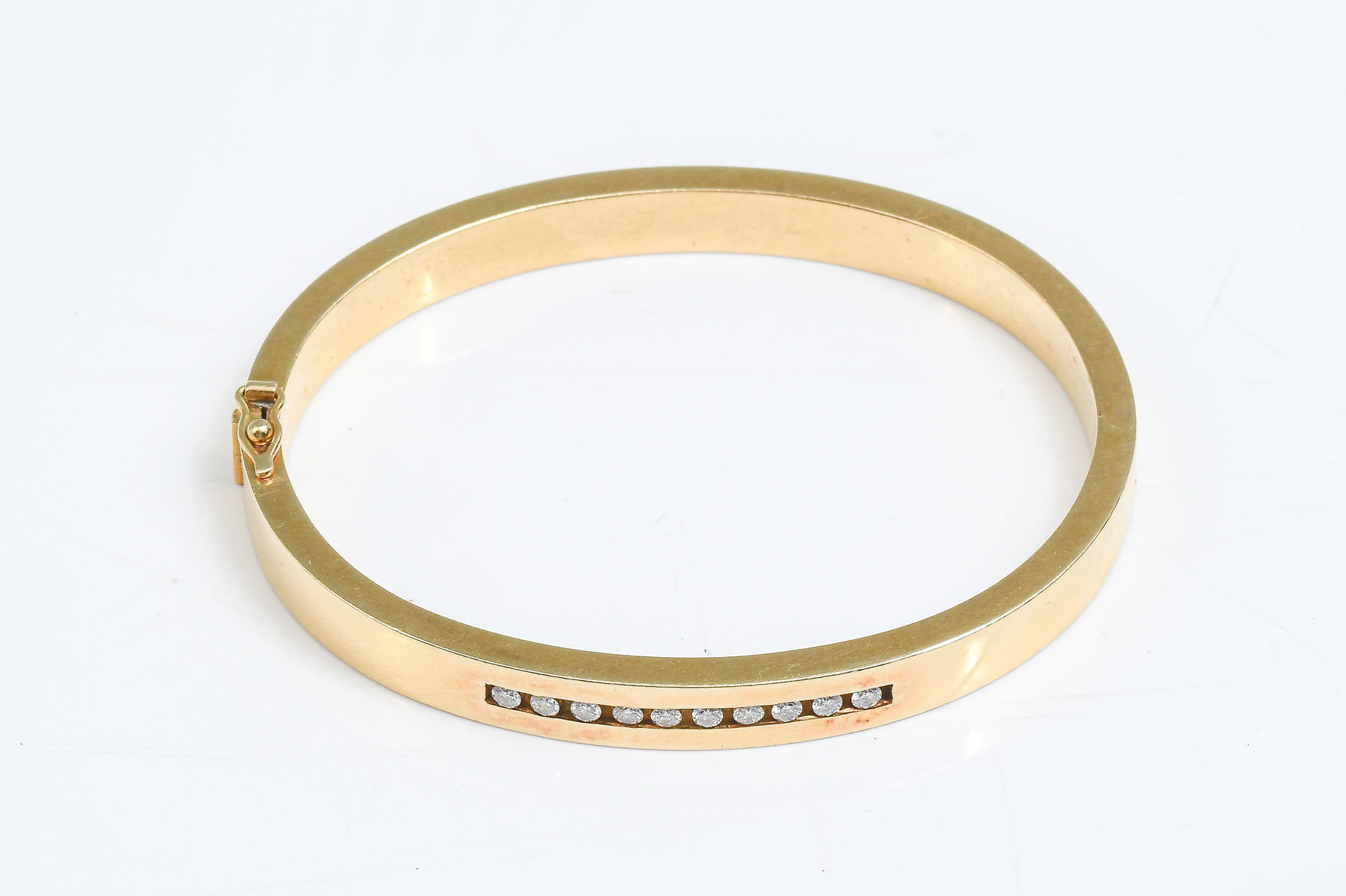 Appraisal: K CHANNEL SET CTW DIAMOND BANGLE K yellow gold bracelet