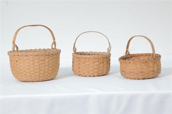 Appraisal: THREE SMALL BASKETS All contemporary miniature egg baskets with swing