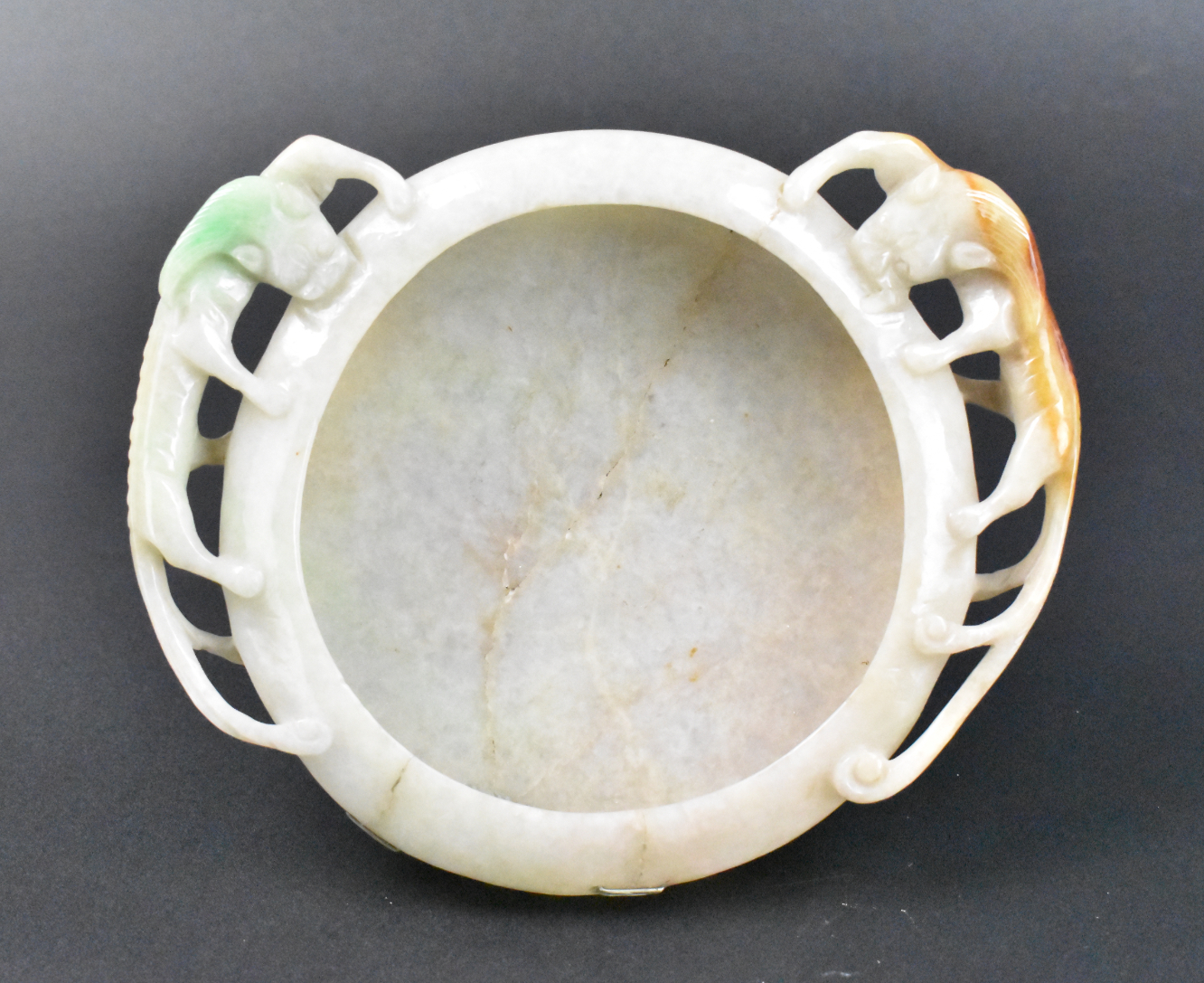 Appraisal: A Chinese jadeite carved washer with Chi dragon design dating