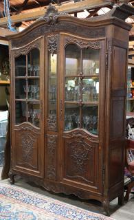 Appraisal: French carved quartersawn oak vitrine French carved quartersawn oak vitrine