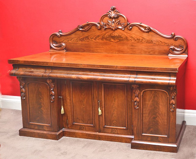 Appraisal: A VICTORIAN MAHOGANY PEDESTAL SIDEBOARD with raised back fitted drawers