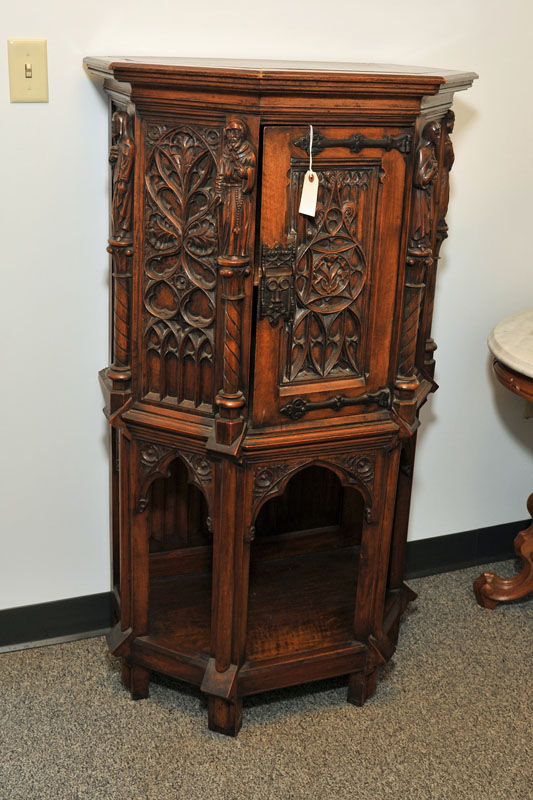 Appraisal: COLBY'S LIQUOR CABINET Walnut and oak Carved cabinet depicting religous