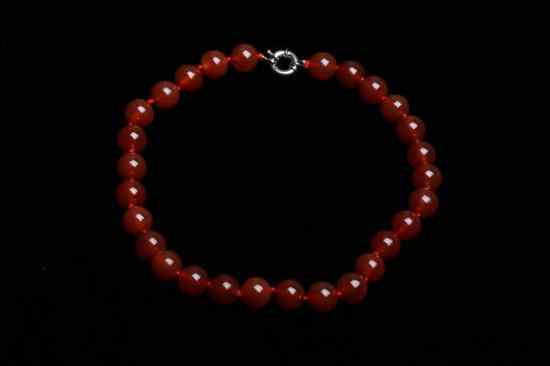 Appraisal: MATCHED NATURAL RED AGATE CHOKER Twenty-eight mm round beads -