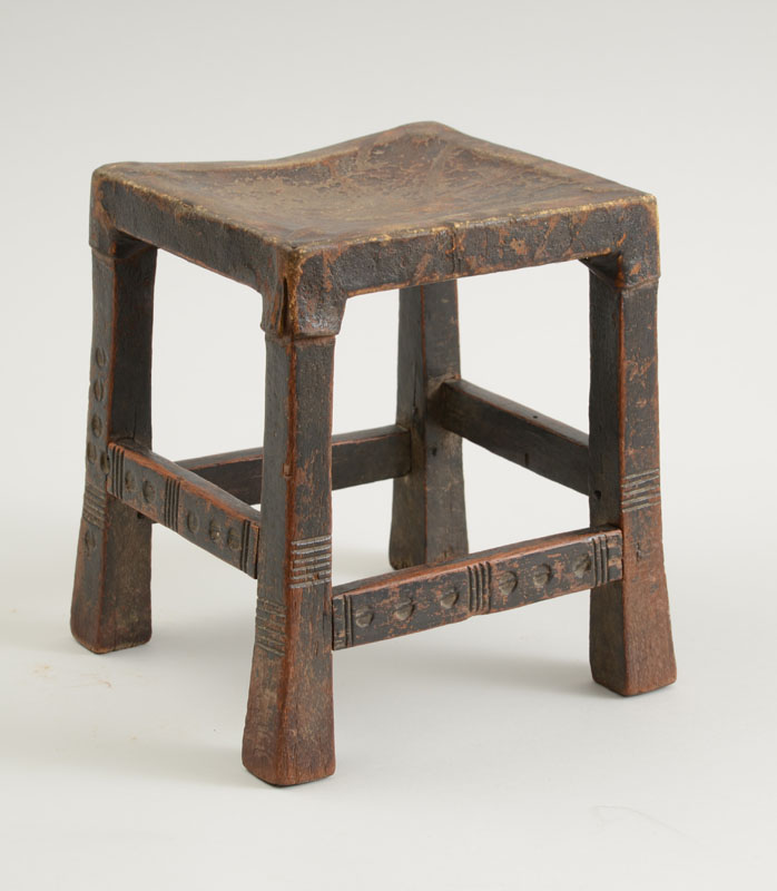 Appraisal: AFRICAN HIDE-COVERED WOOD CHILD'S STOOL The rectangular dipped seat bound