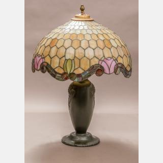 Appraisal: A Patinated Metal and Slag Glass Table Lamp th Century