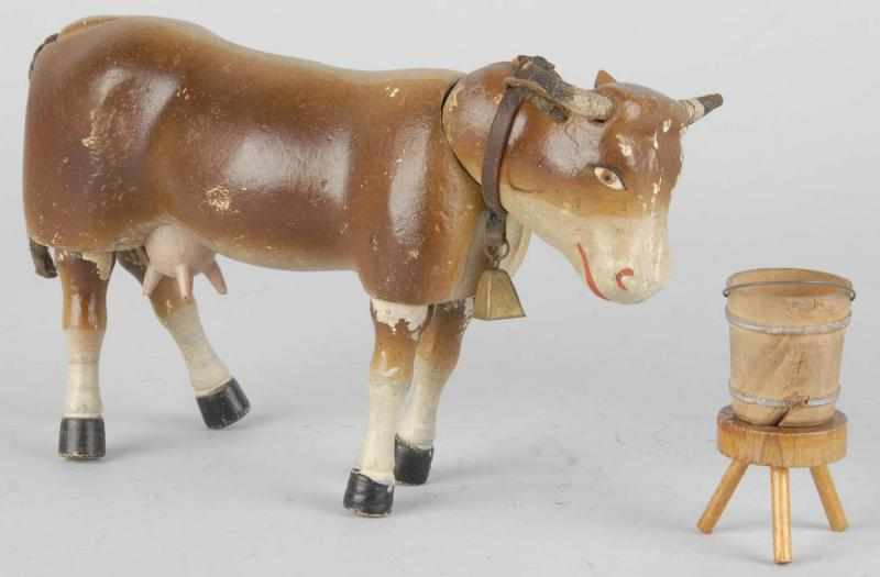 Appraisal: Schoenhut Painted-Eye Cow Description Includes original bell milking stool and