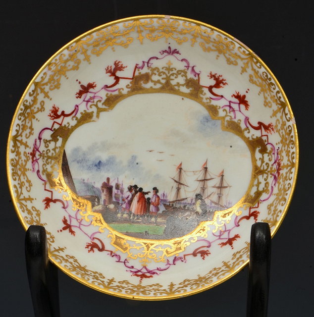 Appraisal: A MEISSEN SAUCER the centre painted with traders at a