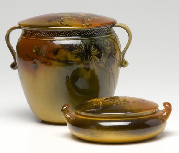 Appraisal: ROOKWOOD Two lidded vessels one with pierced top and leaf