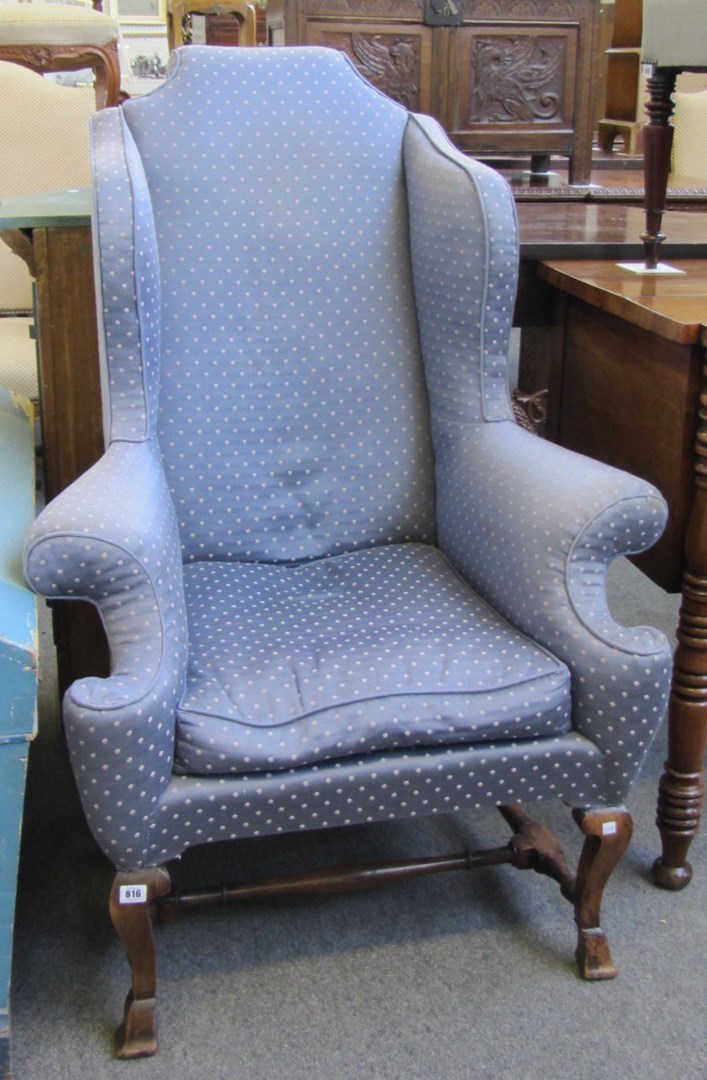 Appraisal: An early th century style wingback armchair on square mahogany