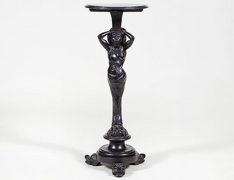 Appraisal: CONTINENTAL EBONIZED CARVED WOOD FIGURAL STANDCirca The circular top above