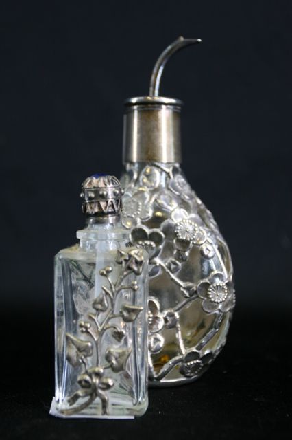 Appraisal: Two silver mounted scent bottles and stoppers in floral decoration