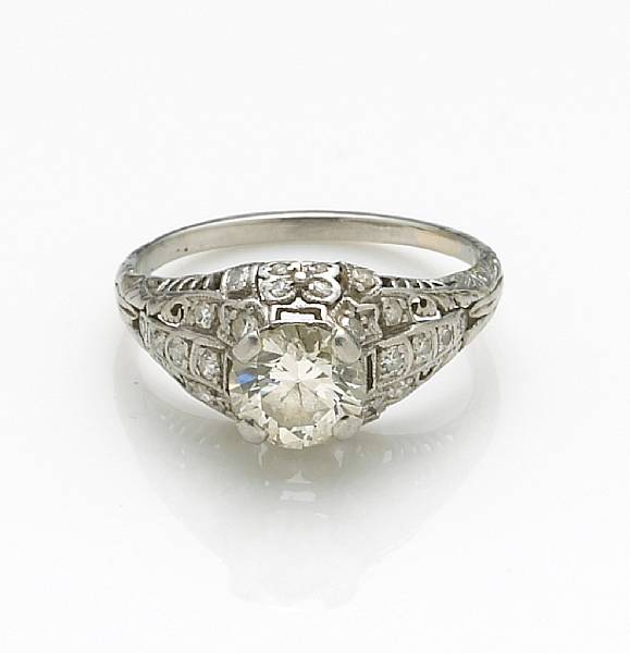 Appraisal: A diamond and platinum ring centering a European-cut diamond weighing