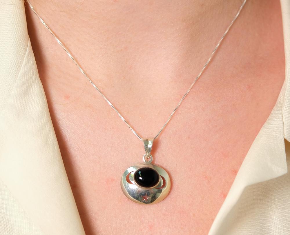 Appraisal: Sterling silver necklace hung with a oval Onyx cabochon and