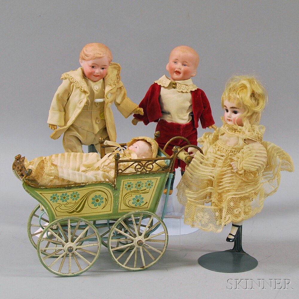 Appraisal: Four Small Bisque Dolls and a Pressed and Painted Tin