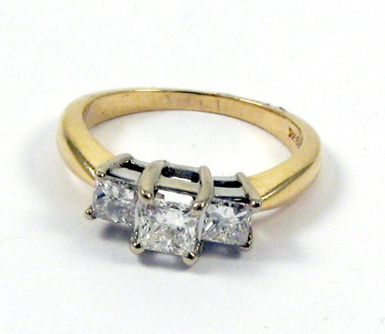 Appraisal: DIAMOND AND FOURTEEN KARAT GOLD RING set with three princess-cut