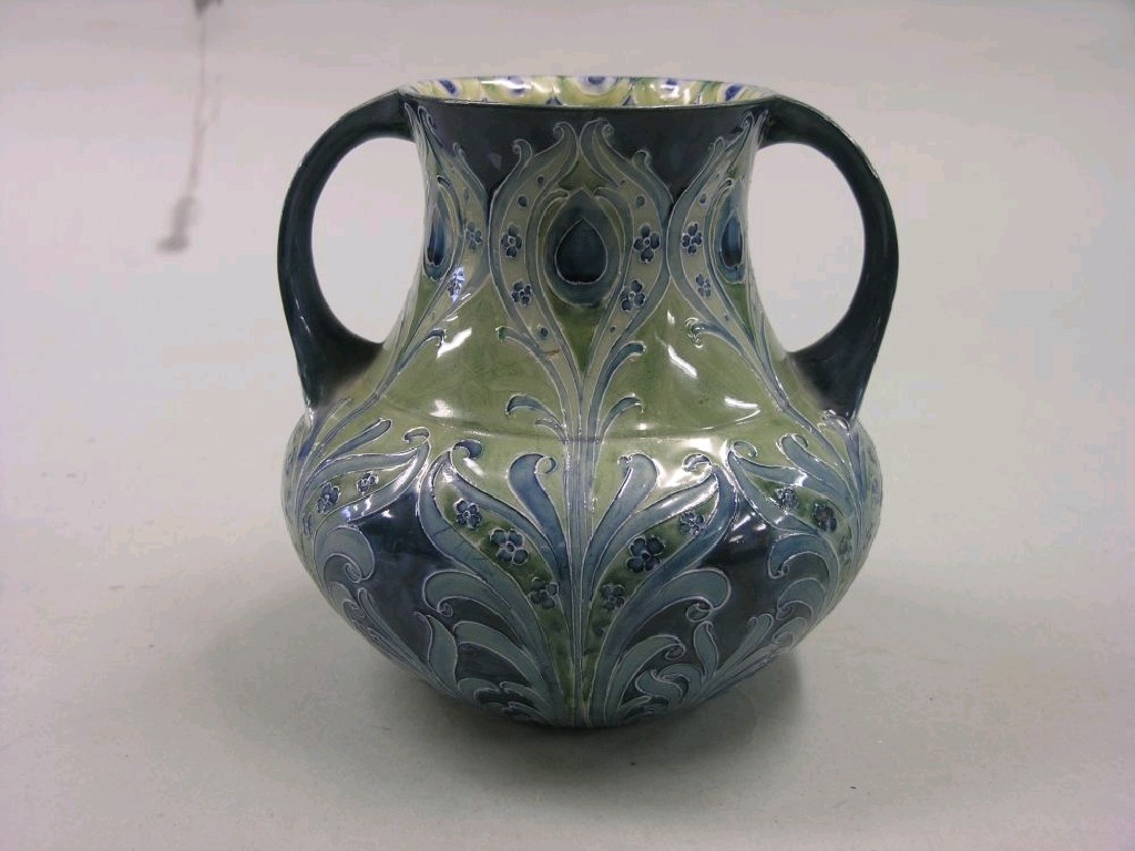 Appraisal: A large Moorcroft Florian Ware vase two-handled bulbous shape painted