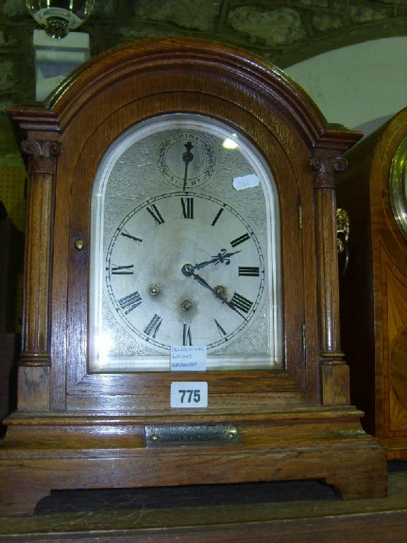 Appraisal: An Edwardian oak bracket clock with ionic column support enclosing