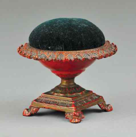 Appraisal: CAST IRON DECORATIVE PIN CUSHION Cast iron pedestaled base circular