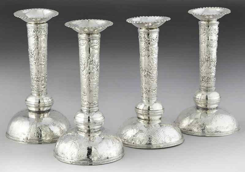 Appraisal: Set Dutch embossed silver candlesticksdepicting outdoors scenes with boats and